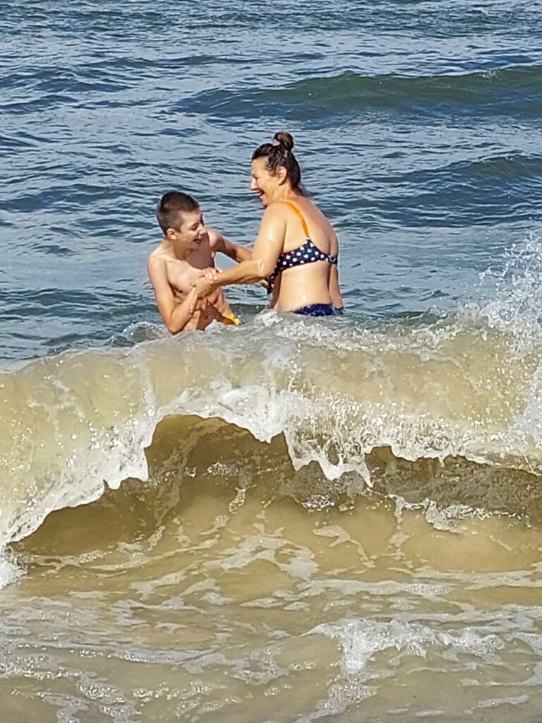kobieta i chłopiec kąpiący się w morzu 