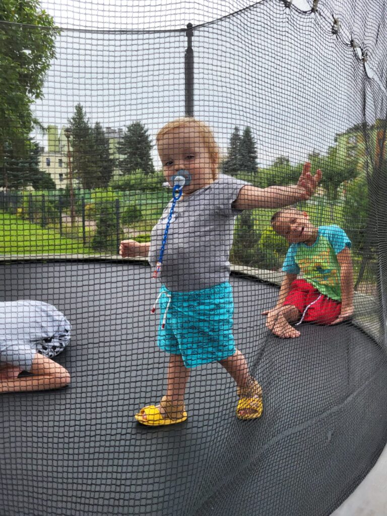 chłopcy bawiący się na trampolinie 